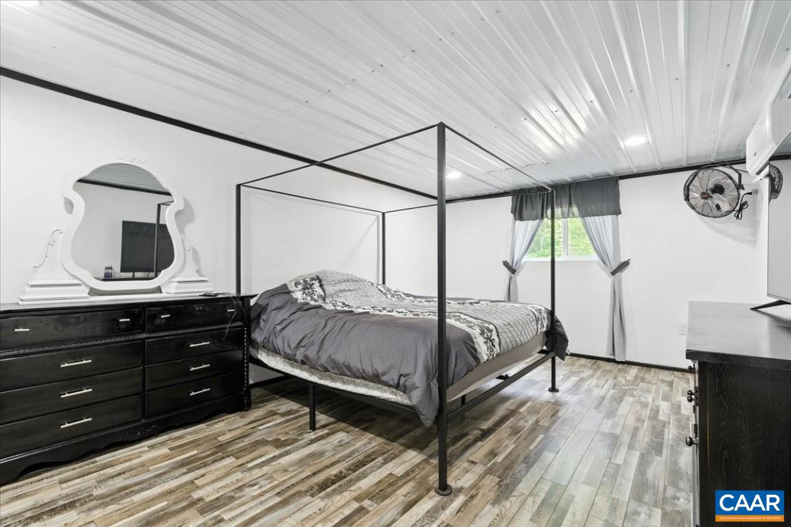 1568 Bent Creek Road Concord, VA 24538 - Photo 69 of 75 a bedroom with a bed and a flat tv screen on dresser