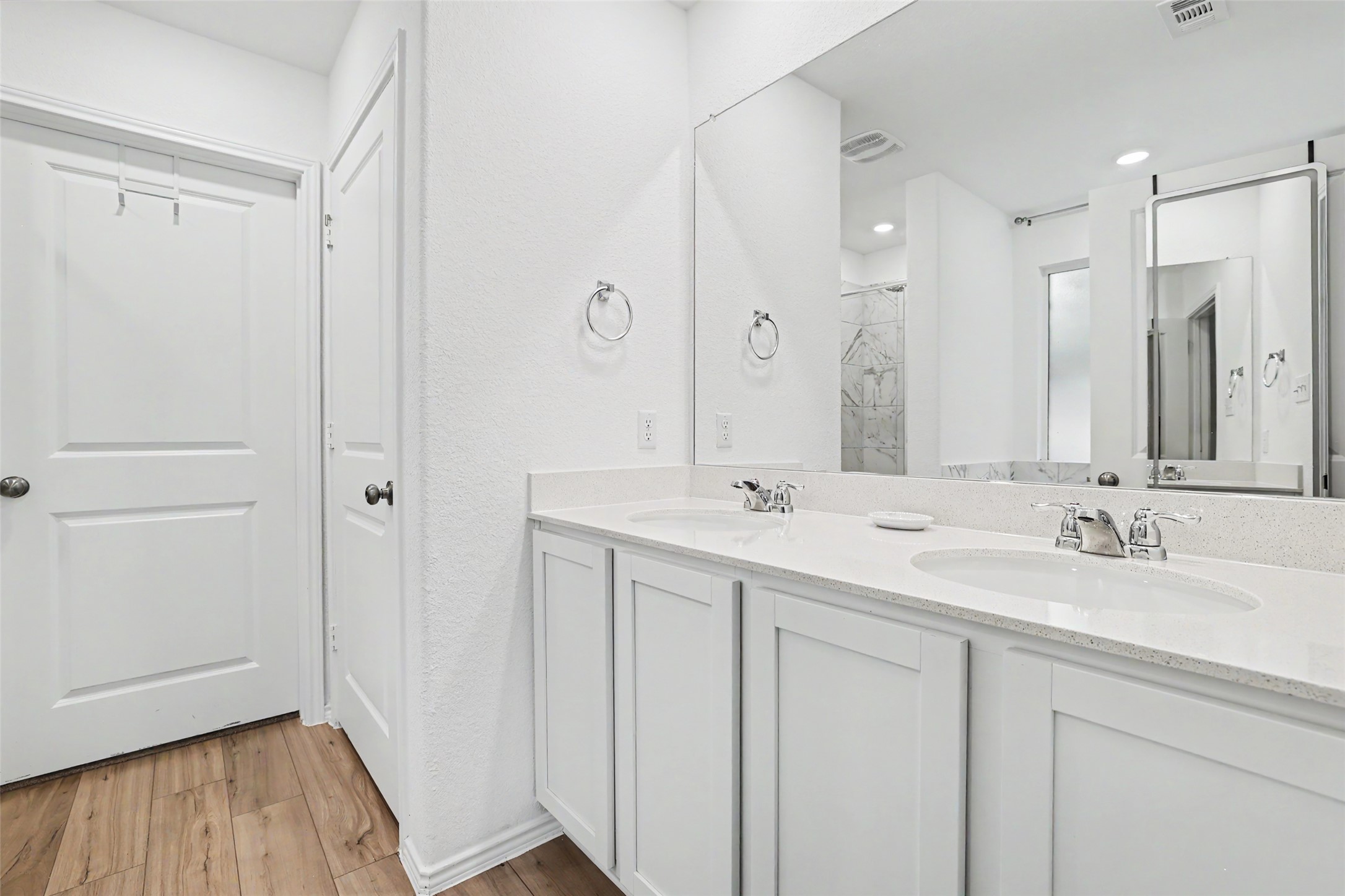 2333 Four Waters Loop Georgetown, TX 78628 - Photo 22 of 35 Double vanity with white cabinetry and integrated sinks set in a light-toned countertop