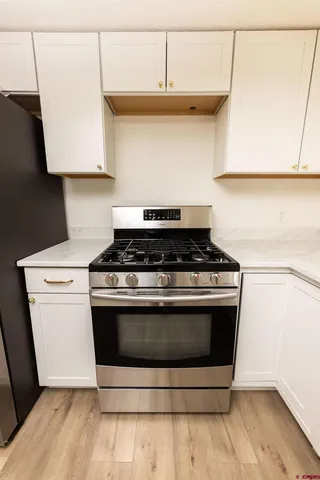 a stove top oven sitting inside of a kitchen
