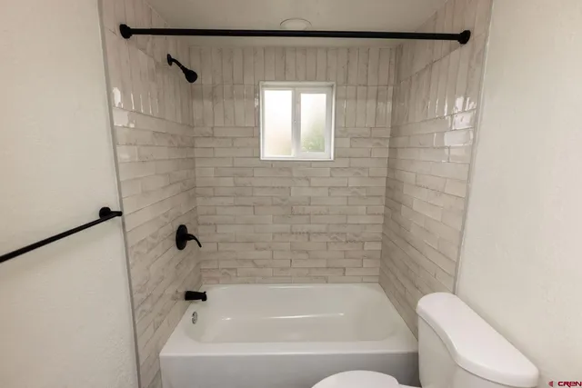 a bathroom with a bathtub and shower