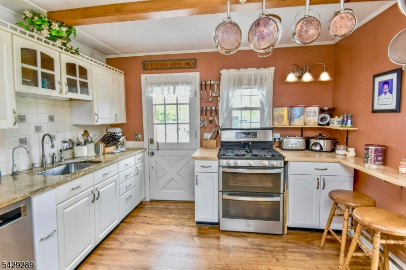 16 Pequot Trail Oak Ridge, NJ 07438 - Photo 5 of 18 a kitchen with stainless steel appliances granite countertop a stove and a sink