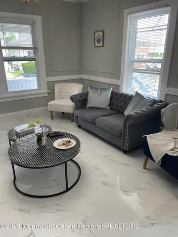 a living room with furniture a window and a table