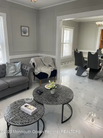 a living room with furniture a rug and a table