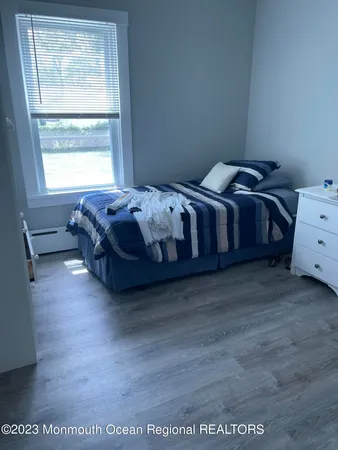 a spacious bedroom with a bed and a window