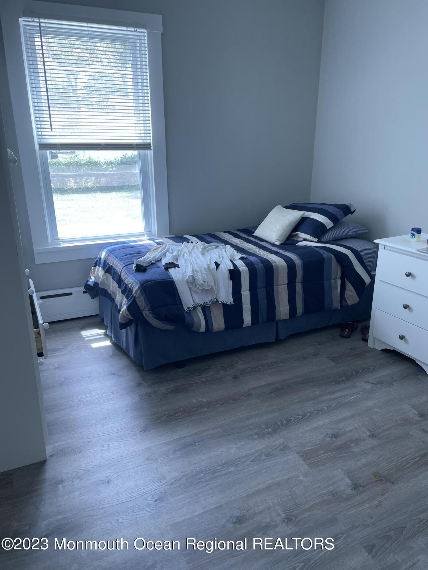 12 Wyckoff Street Deal, NJ 07723 - Photo 6 of 6 a spacious bedroom with a bed and a window