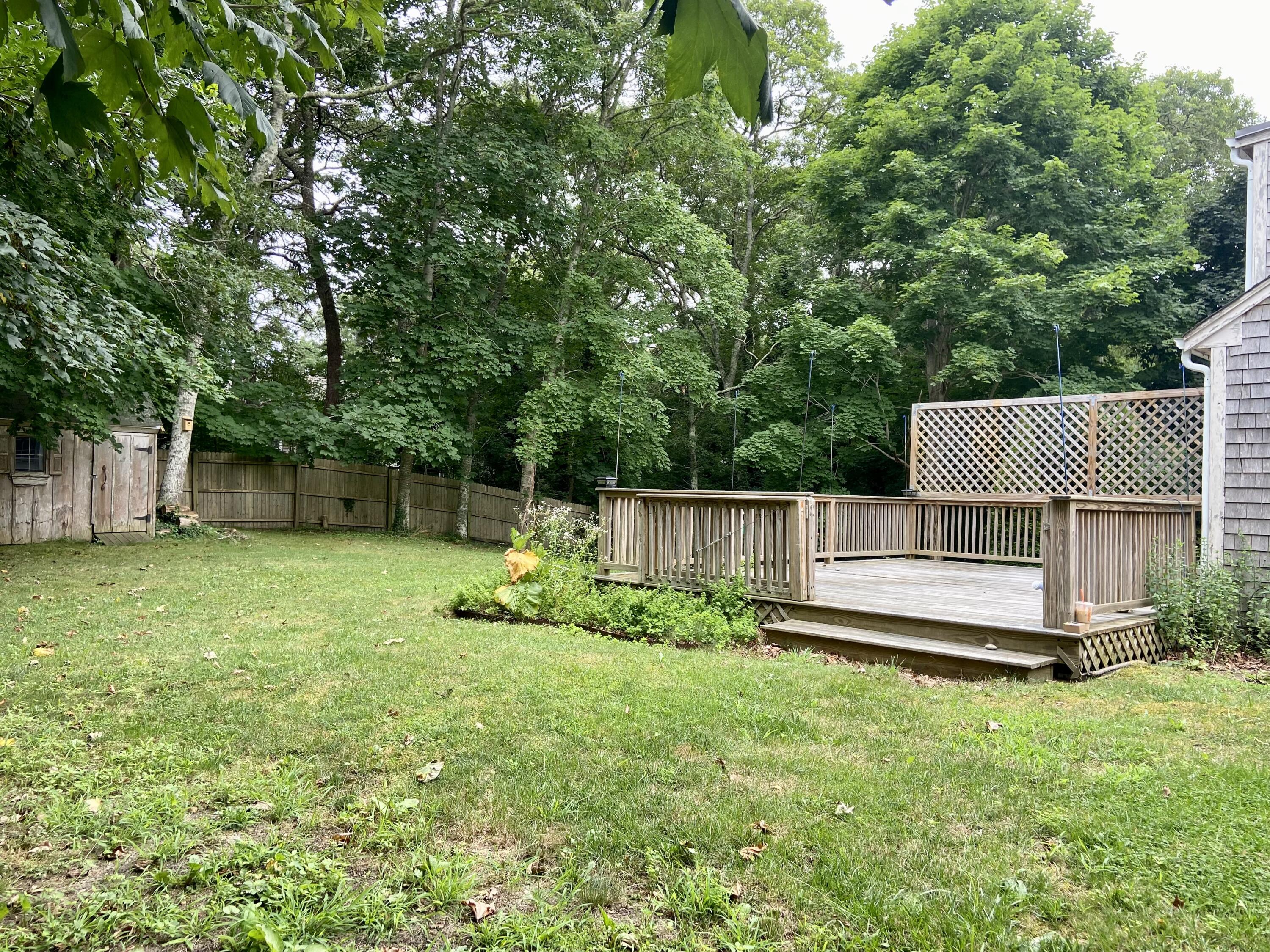 43 Bay Road Harwich, MA 02645 - Photo 18 of 24 a small white house with a small yard and large trees