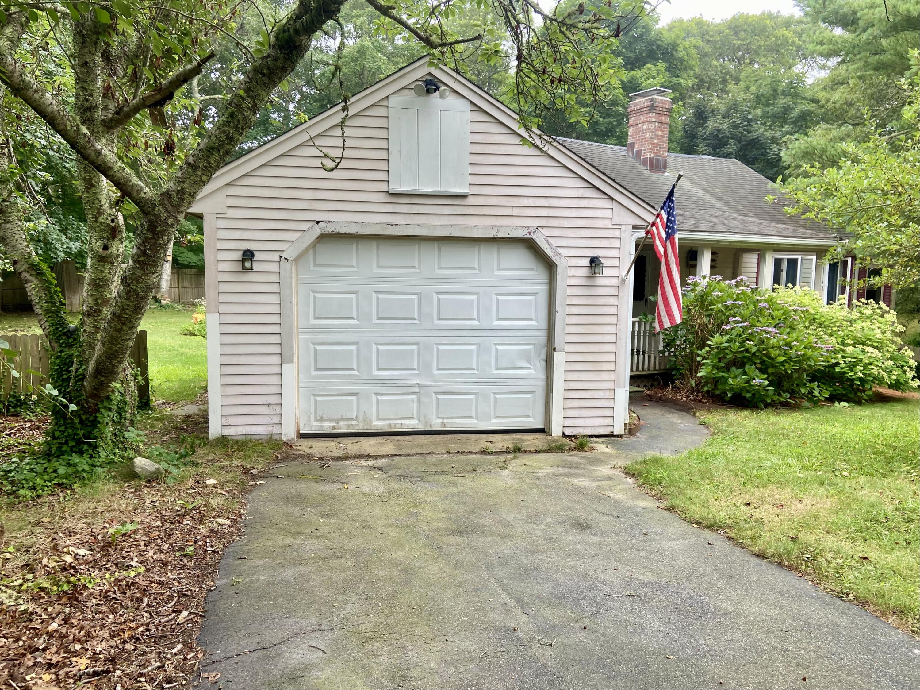 43 Bay Road Harwich, MA 02645 - Photo 2 of 24 a front view of a house with a yard and garage
