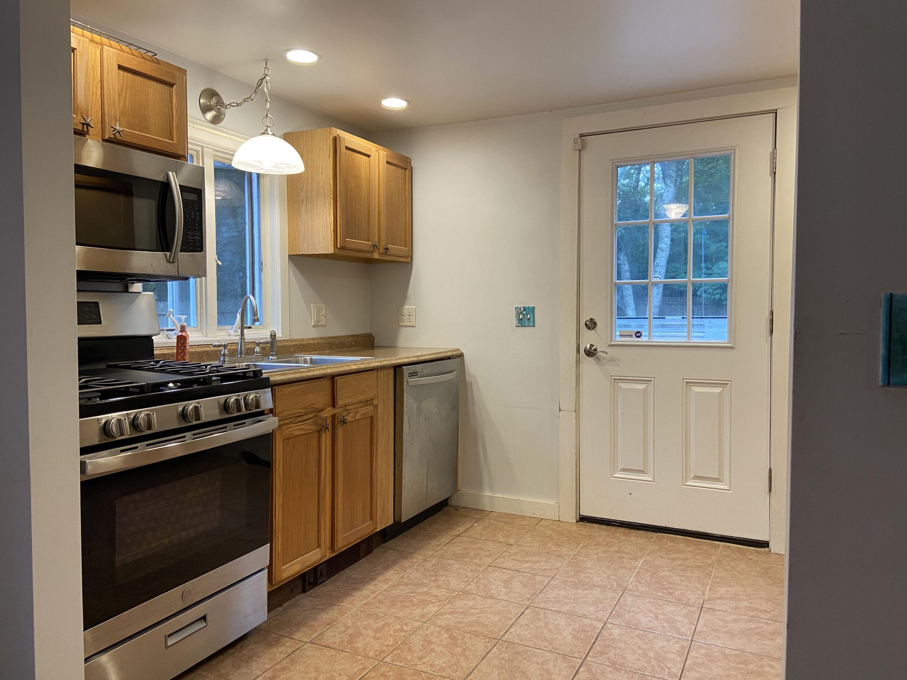 43 Bay Road Harwich, MA 02645 - Photo 7 of 24 a kitchen with stainless steel appliances granite countertop a stove and a refrigerator