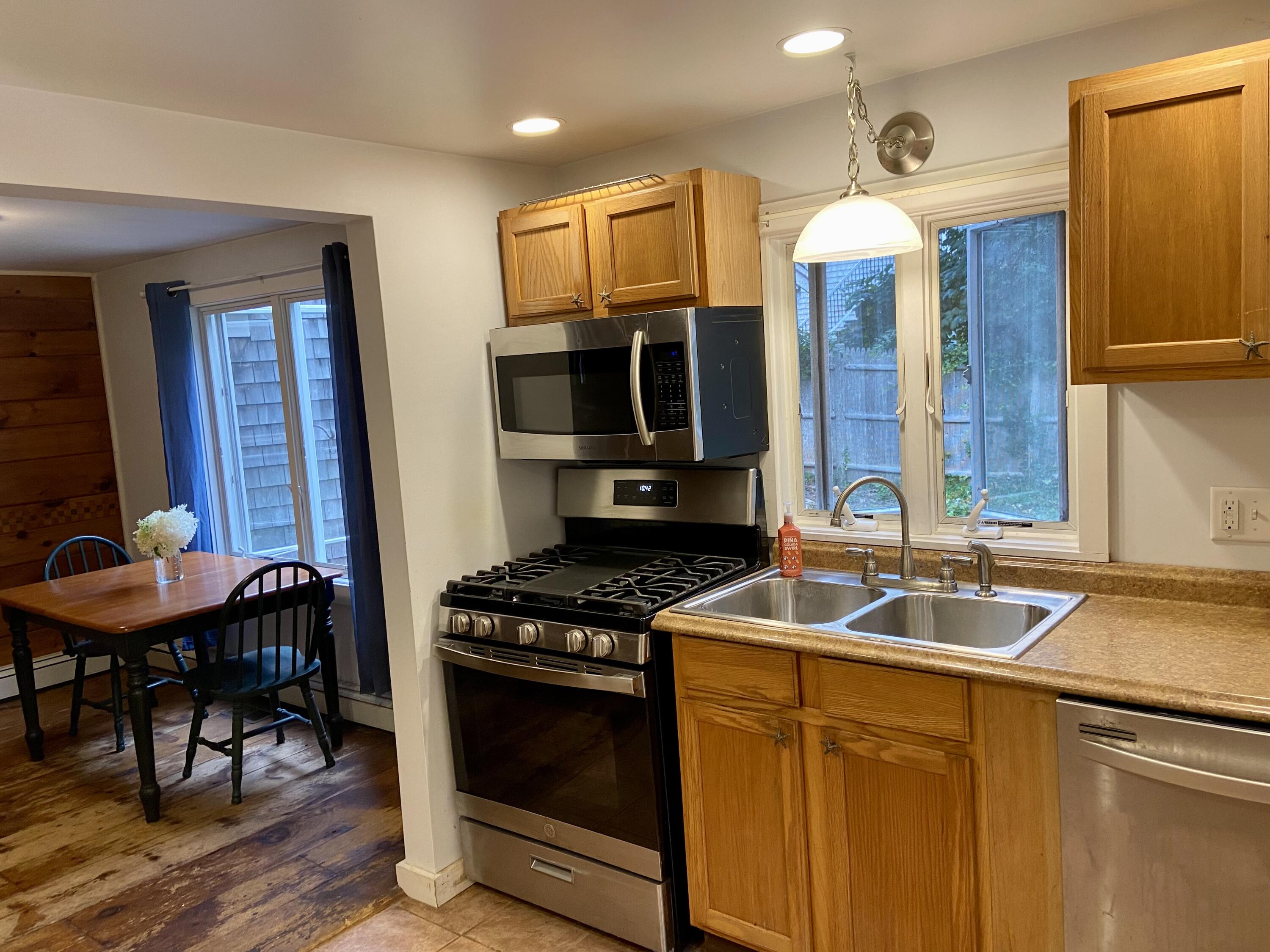 43 Bay Road Harwich, MA 02645 - Photo 9 of 24 a kitchen that has a sink and a stove with wooden floor