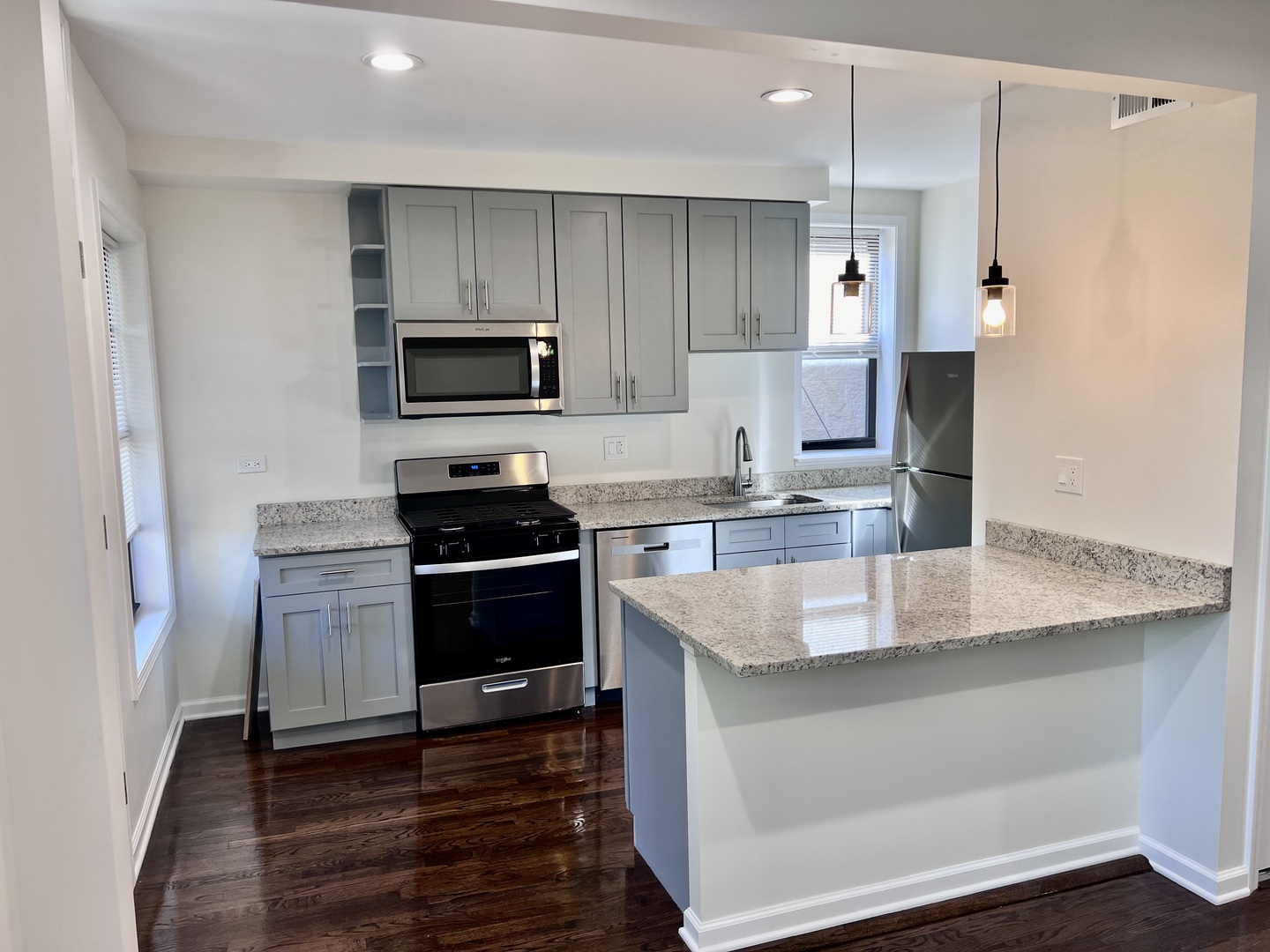 3051 North Racine Avenue, Unit 3F Chicago, IL 60657 - Photo 2 of 21 a kitchen with granite countertop a stove and a refrigerator