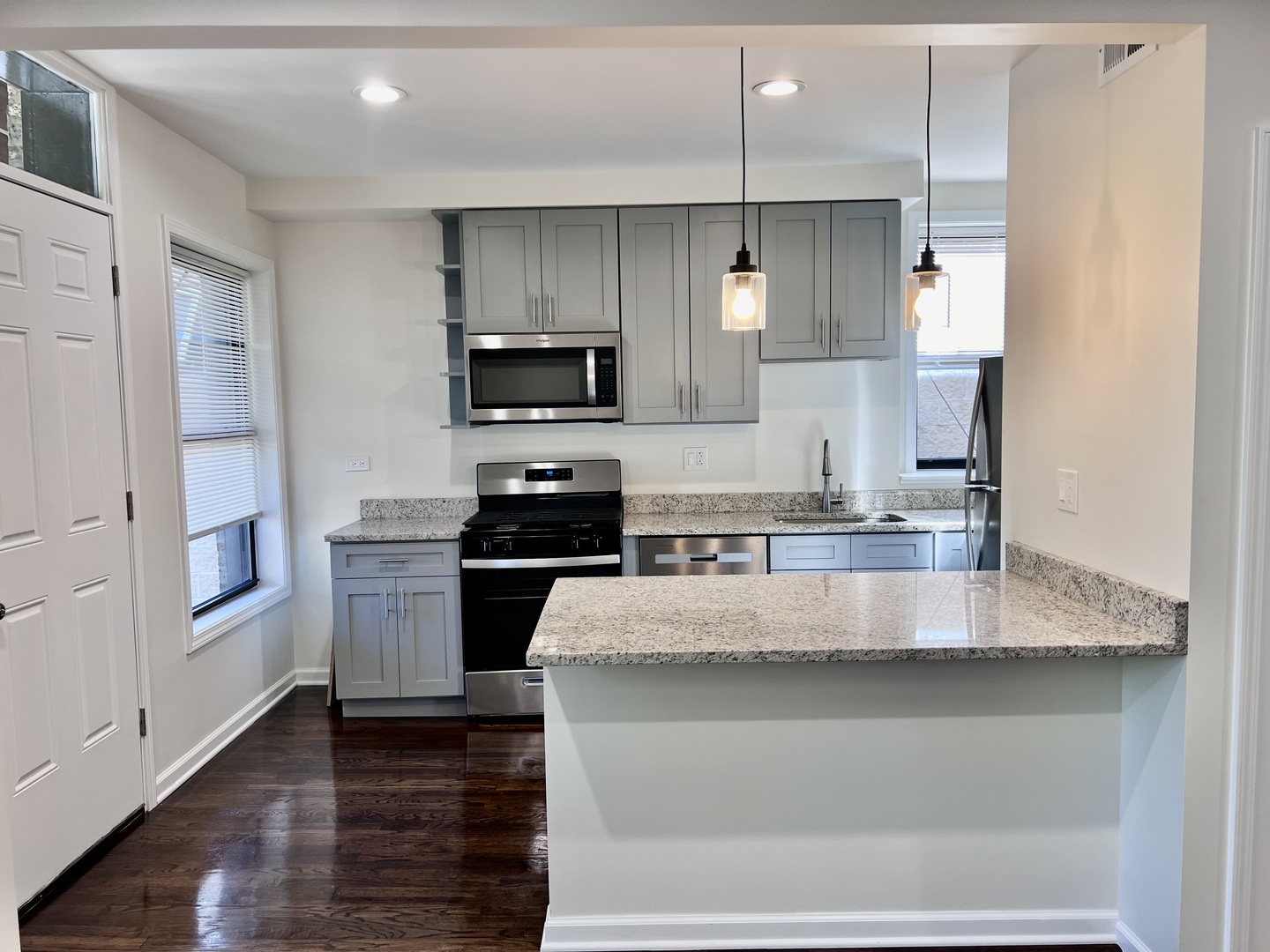 3051 North Racine Avenue, Unit 3F Chicago, IL 60657 - Photo 3 of 21 a large kitchen with granite countertop a sink a counter space stainless steel appliances and cabinets