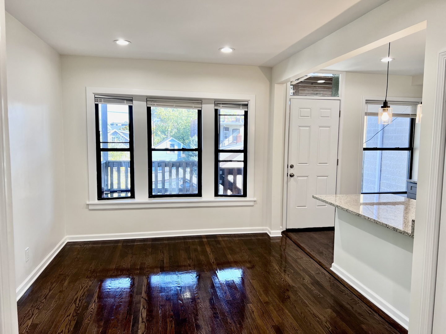 3051 North Racine Avenue, Unit 3F Chicago, IL 60657 - Photo 5 of 21 wooden floor in an empty room with a window