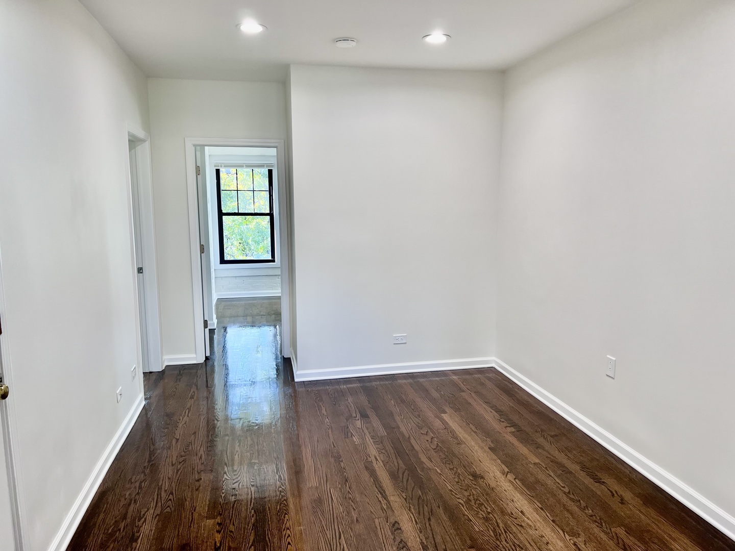 3051 North Racine Avenue, Unit 3F Chicago, IL 60657 - Photo 7 of 21 a view of wooden floor and windows in a room