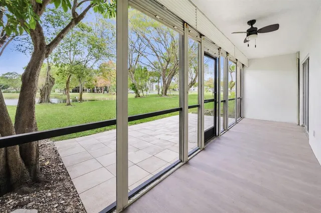 a view of a room with wooden floor and ceiling fan