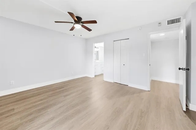 a view of a room with a ceiling fan and a window