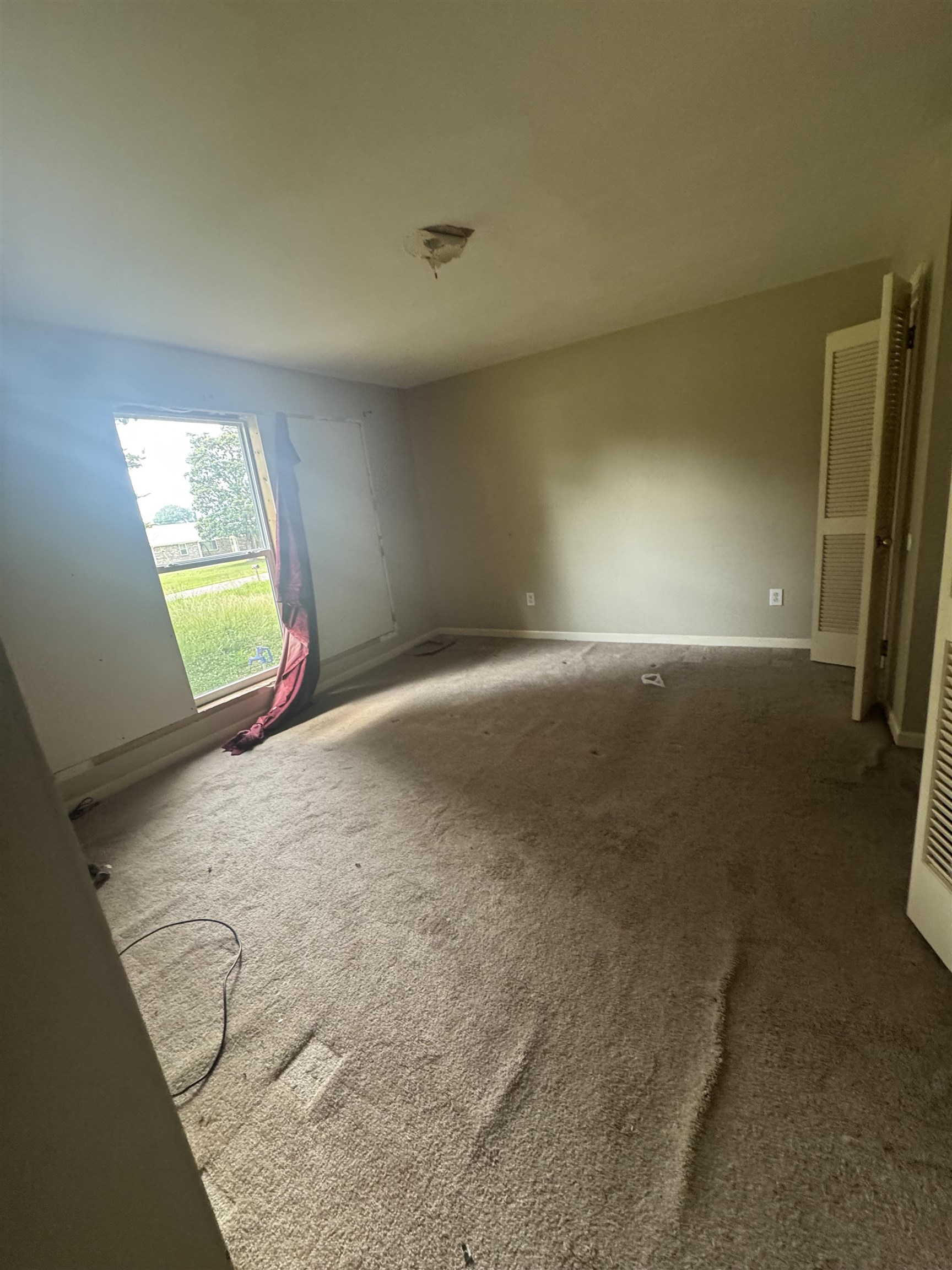 106 Cole Road Drummonds, TN 38023 - Photo 14 of 21 Room with beige carpeting, a single window, and a ceiling-mounted light fixture