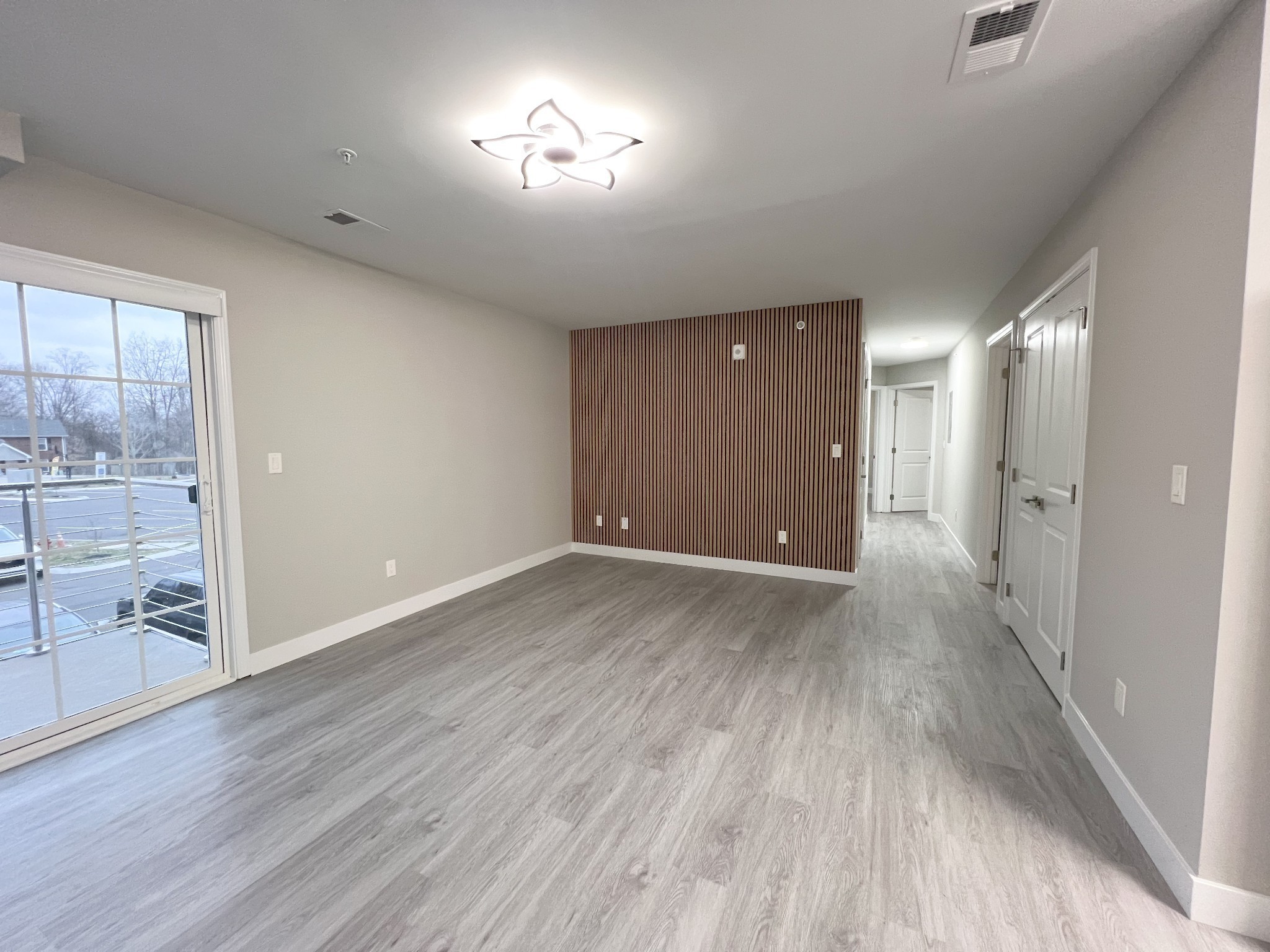 543 Peachers Mill Road, Unit 209 Clarksville, TN 37042 - Photo 3 of 21 an empty room with wooden floor and windows