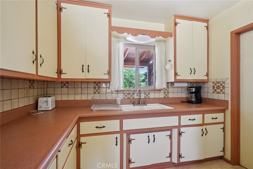 61494 Sunburst Drive Joshua Tree, CA 92252 - Photo 12 of 31 a kitchen with a sink and a window