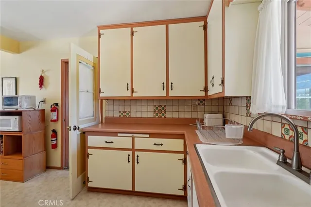 a kitchen with stainless steel appliances granite countertop a sink and a refrigerator