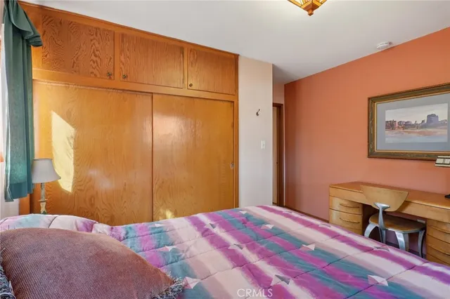 a bedroom with a bed and a dresser