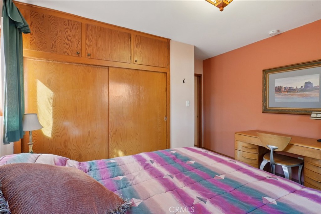 61494 Sunburst Drive Joshua Tree, CA 92252 - Photo 15 of 31 a bedroom with a bed and a dresser