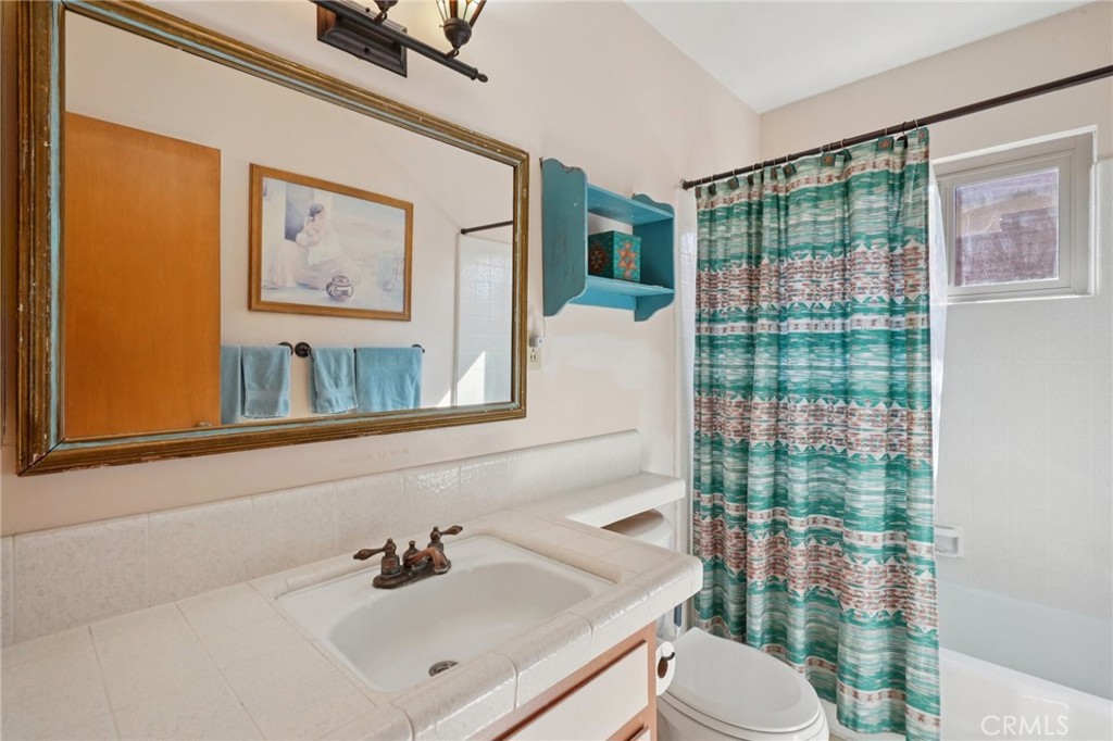 61494 Sunburst Drive Joshua Tree, CA 92252 - Photo 16 of 31 a bathroom with a sink vanity mirror and toilet