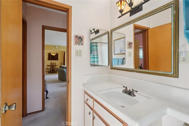 a en suite bathroom with a granite countertop sink