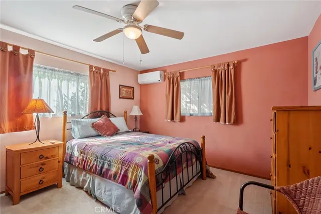 a bedroom with a bed and ceiling fan