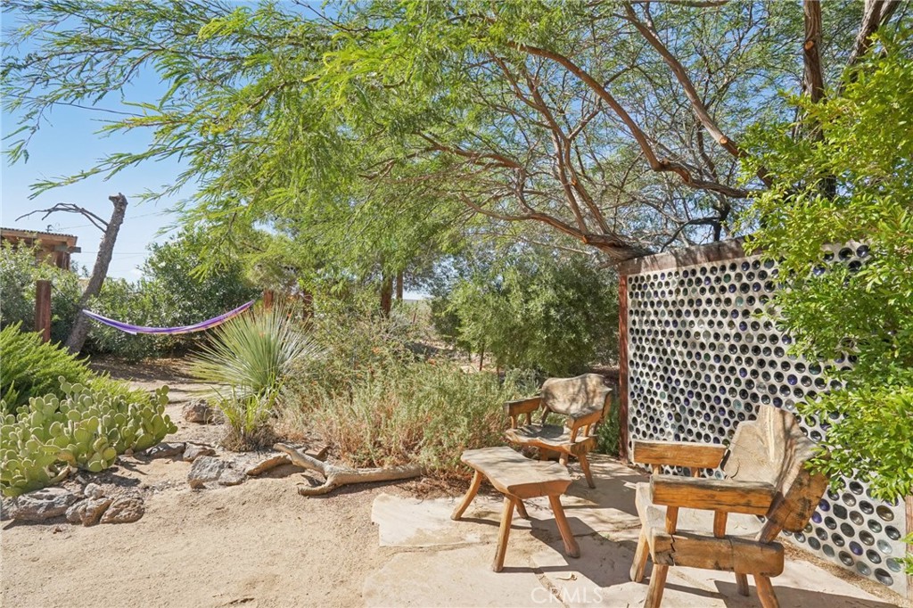 61494 Sunburst Drive Joshua Tree, CA 92252 - Photo 24 of 31 a view of a chairs and table in the backyard