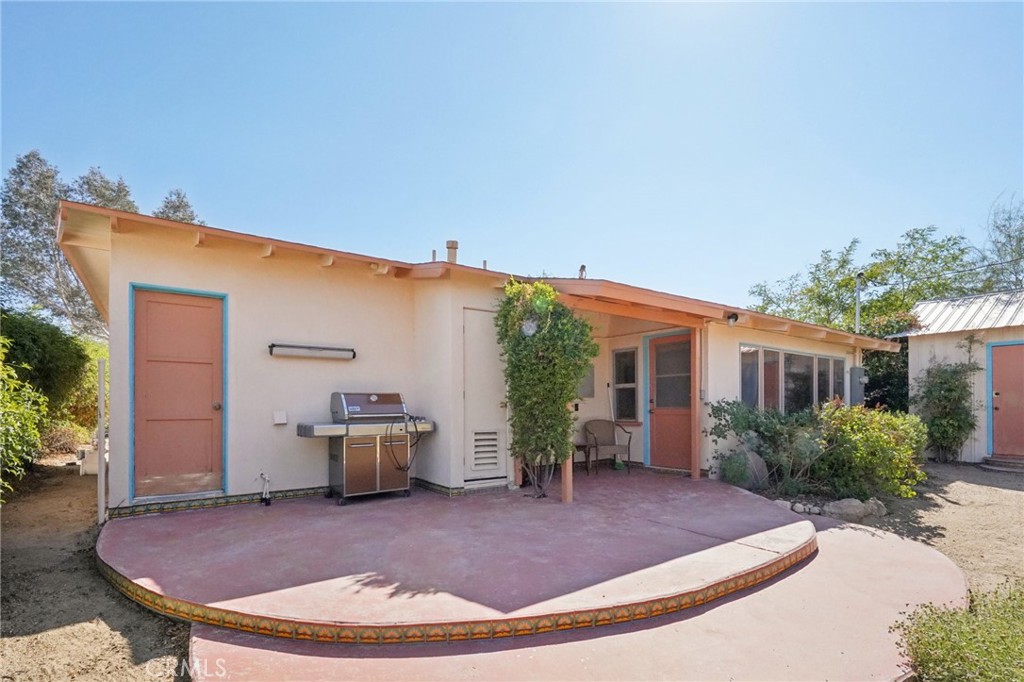 61494 Sunburst Drive Joshua Tree, CA 92252 - Photo 26 of 31 a view of a backyard with plants and barbeque grill