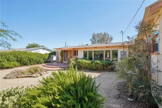 a front view of house with yard and outdoor seating