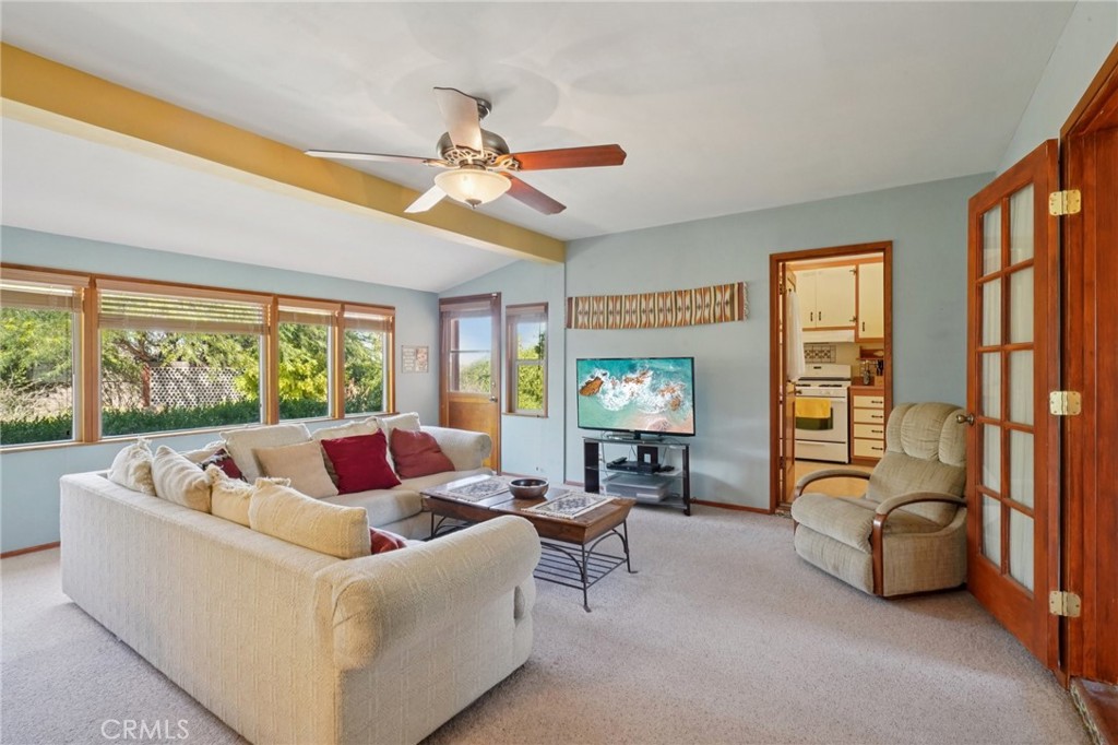 61494 Sunburst Drive Joshua Tree, CA 92252 - Photo 3 of 31 a living room with furniture a flat screen tv and a large window
