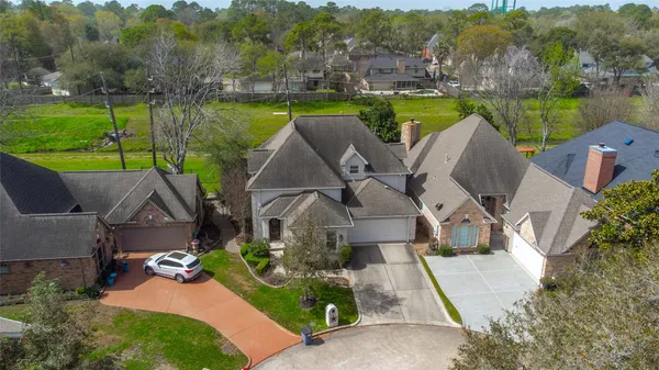 an aerial view of a house with garden space and lake view