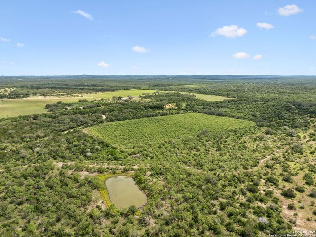 an aerial view of a houses with a yard