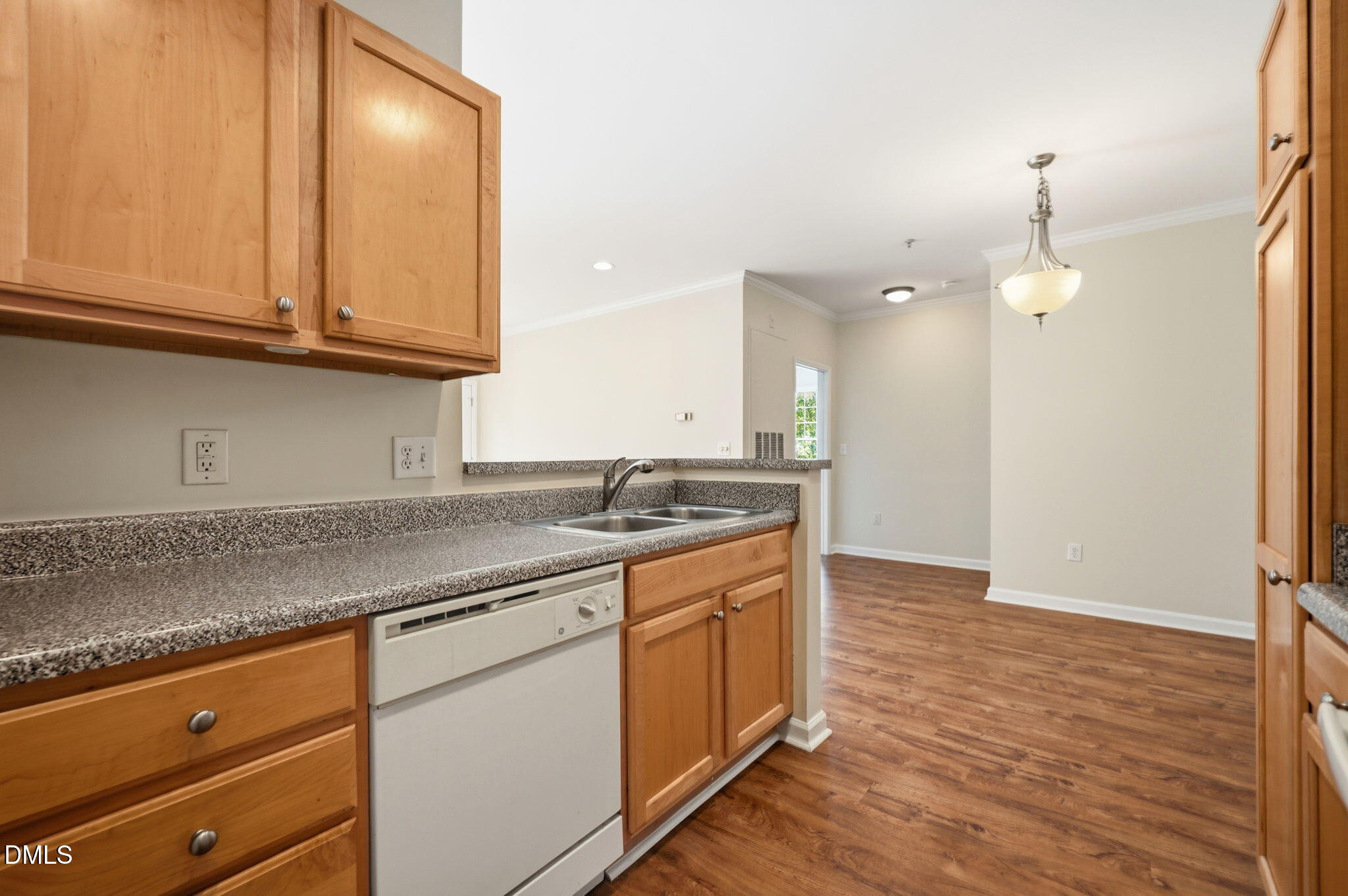 801 Moratuck Drive, Unit 202 Raleigh, NC 27604 - Photo 11 of 23 a kitchen with granite countertop a sink cabinets and stainless steel appliances
