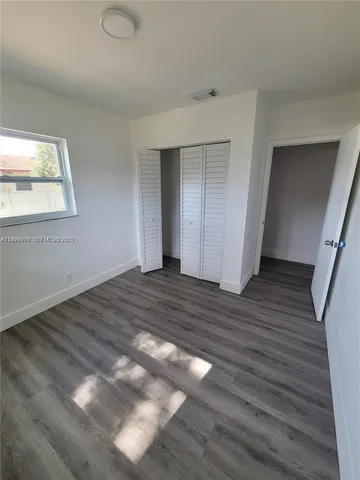 a view of an empty room and wooden floor