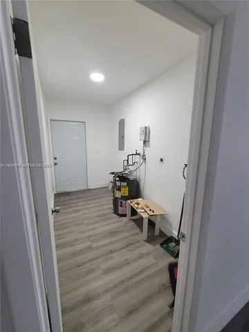 a room with wooden floor and furniture