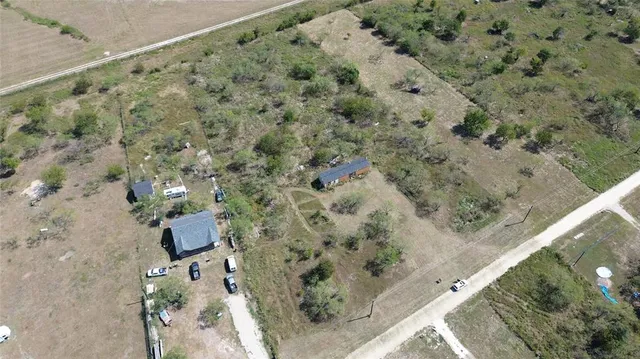 an aerial view of a house with a yard