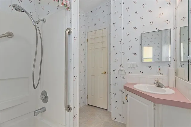 a bathroom with a sink a mirror and shower