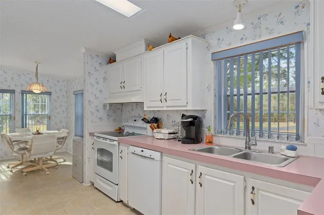 a kitchen with a sink stove and cabinets