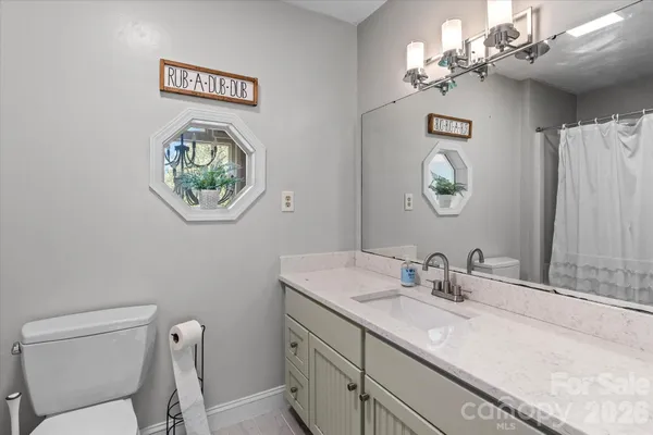 a view of a bathroom with a sink and a mirror