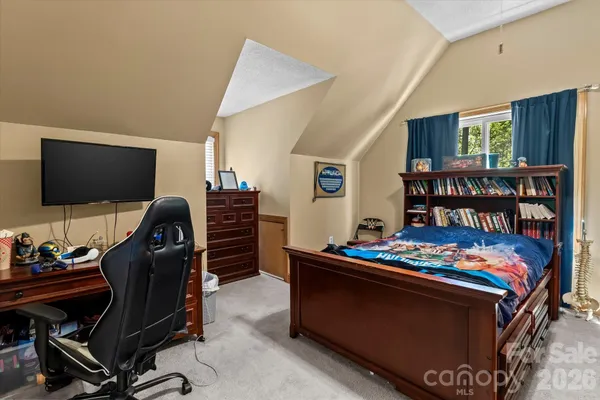 a room with furniture and book shelf