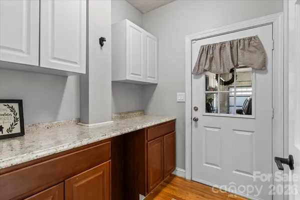 a kitchen with granite countertop a sink and cabinets
