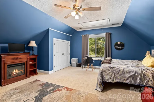 a bedroom with furniture and a fireplace