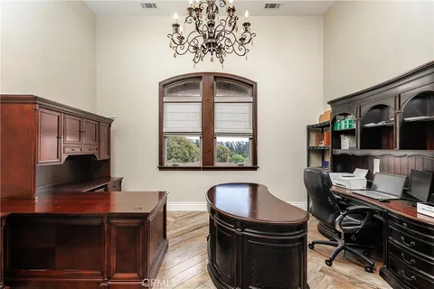 a view of a workspace with furniture and a window