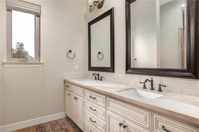 a bathroom with a double vanity sink and mirror