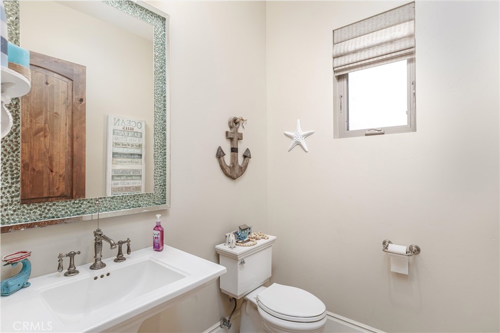 1950 Lemon Ranch Road Arroyo Grande, CA 93420 - Photo 25 of 38 a bathroom with a toilet a sink and mirror