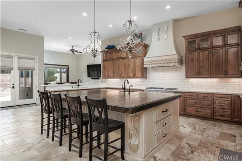 a kitchen with a table chairs stove and cabinets