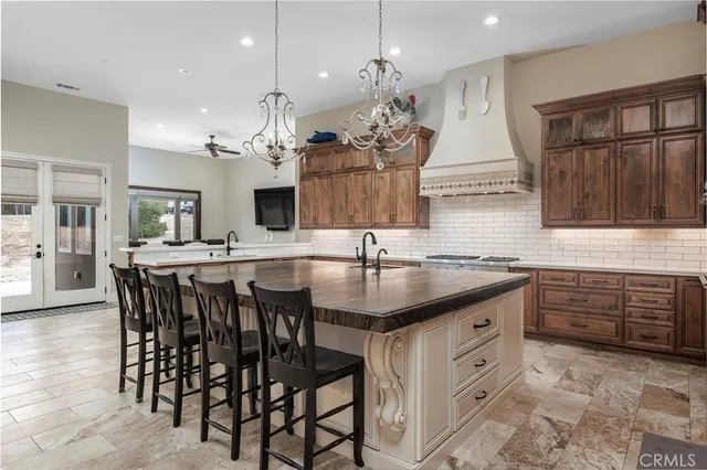 a kitchen with a table chairs stove and cabinets
