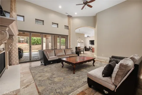 a living room with furniture fireplace and flat screen tv